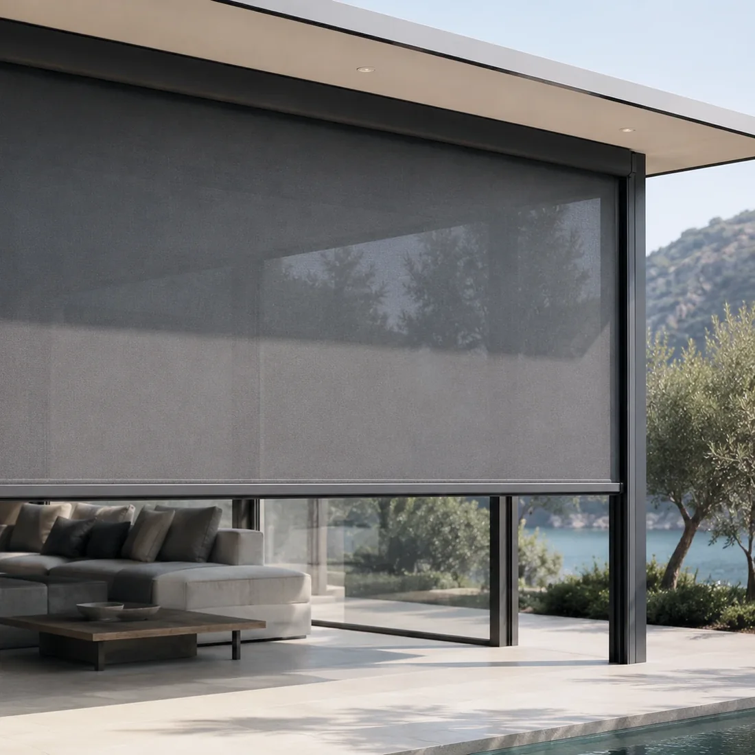 An outdoor blind drawn down across a covered terrace.