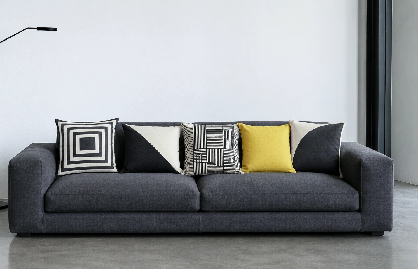 Cushions in close neutrals with one strong yellow, the bright one clearly the subject.