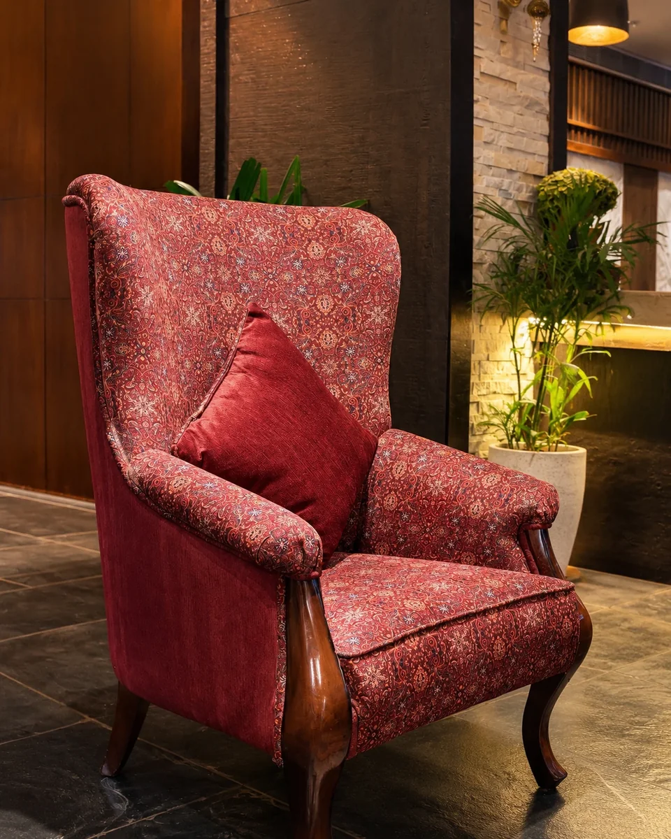 A wing chair recovered in a madder-ground floral.